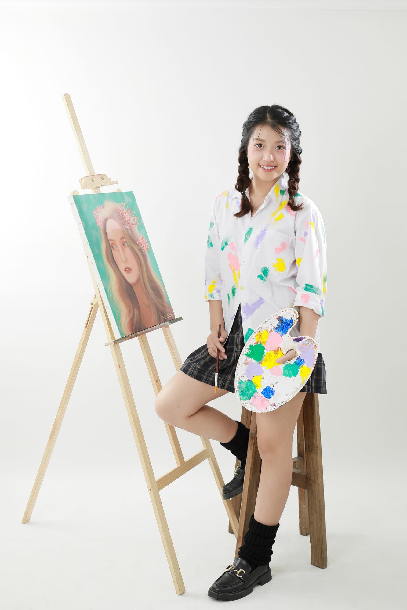Thalia Halim working on a hand-painted portrait